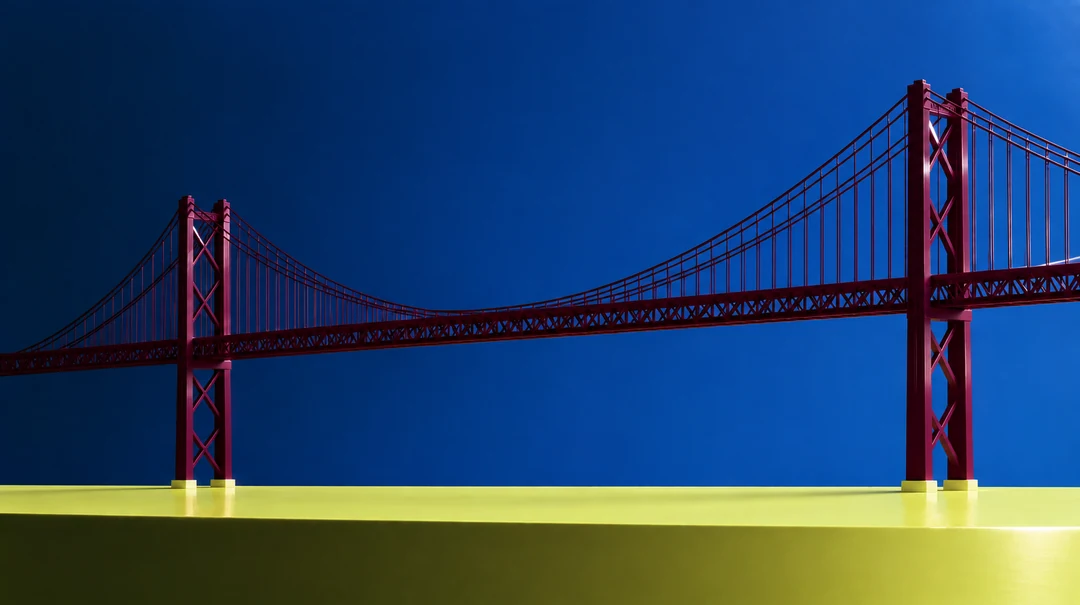 The 25 de Abril bridge in deep red against a deep blue sky, above a band of yellow